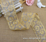 Gold lace ribbon embroidered on organza with oval patterns, about 2 1/4 inches wide , priced for 1 yard. EE-09-01