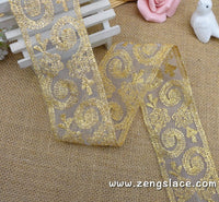 Gold lace ribbon embroidered on organza with oval patterns, about 2 1/4 inches wide , priced for 1 yard. EE-09-01