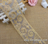 Gold lace ribbon embroidered on organza with oval patterns, about 2 1/4 inches wide , priced for 1 yard. EE-09-01